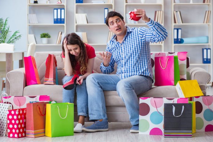 Young Pair After Shopping With Many Bags