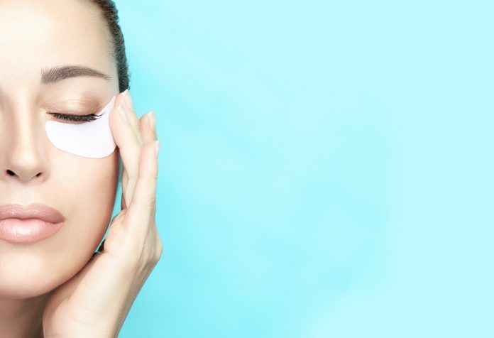 Beauty Face Woman With Mask Under Eyes. Skin Care Concept Anti Aging Eye Mask Cosmetic