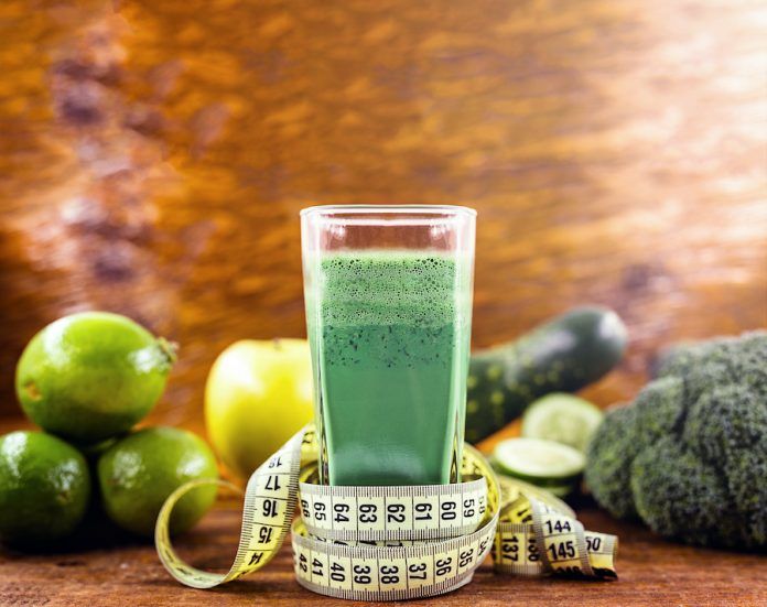 Brazilian Detox Juice And Measuring Tape. Detox Drinks, Green Juice, Vegetables And Vegetables And Measuring Tape On A Wooden Background. Detox Copy Space