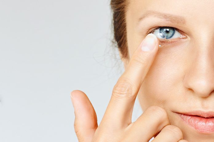Young Woman Puts Contact Lens In Her Eye. Eyewear, Eyesight And Vision, Eye Care And Health, Ophthalmology And Optometry Concept