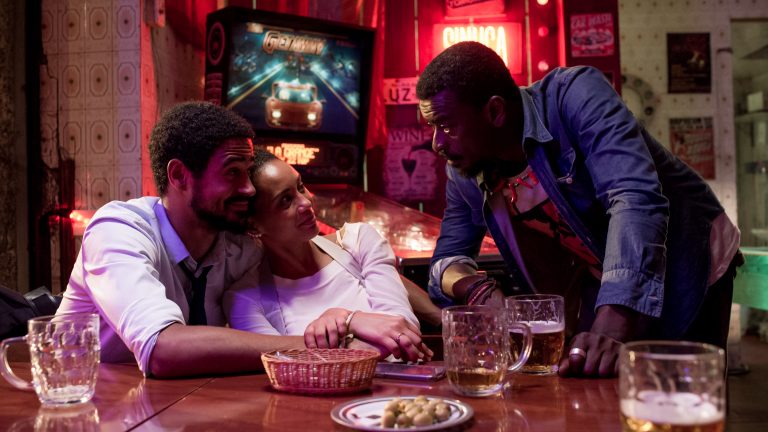 Cópia De Cópia De EXECUTIVE ORDER STILL 2 Alfred Enoch (left), Taís Araújo, And Seu Jorge. Photo By Mariana Vianna